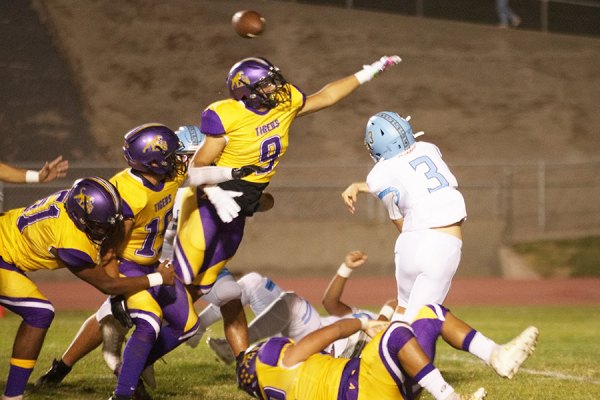 Linebacker Kevin Valdivia harasses the South quarterback in Tigers' 54-0 victory Friday night in Tiger Stadium.